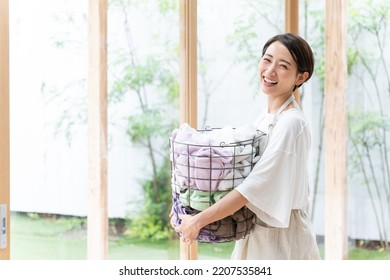 Middle Aged Asian Woman Doing Laundry