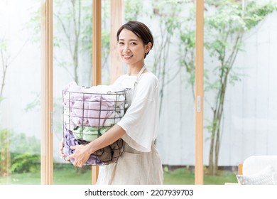 Middle Aged Asian Woman Doing Laundry