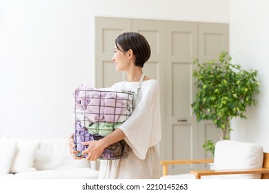 Middle Aged Asian Woman Doing Laundry