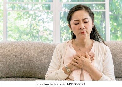 Middle Aged Asian Woman Having A Chest Pain.