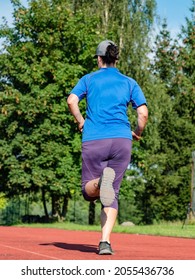 Middle Aged Asian Woman Running On Red Race Track, Healthy Fitness Lifestyle