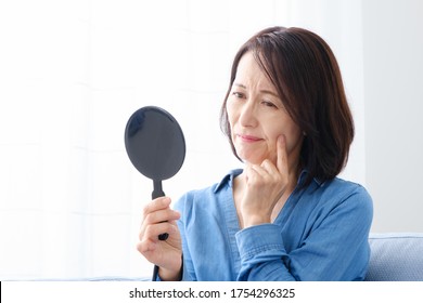 middle aged asian woman skincare image