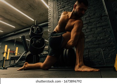Middle aged attractive man practicing yoga concept, sitting in difficult pose, working out wearing black sportswear. Healthy lifestyle concept. - Shutterstock ID 1673896792