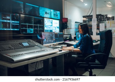 Middle Aged Beautiful Woman Working In A Broadcast Control Room On A Tv Station. Entertainment News With Footage Equipment Concept. Focus On A Woman Working In A Broadcast Room. Copy Space.