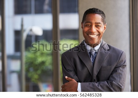 Middle aged black businessman looking at camera