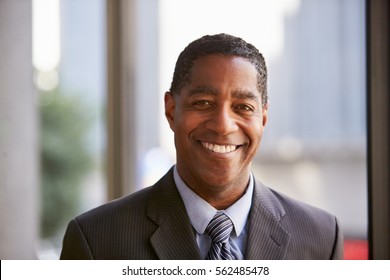 Middle aged black businessman smiling to camera - Shutterstock ID 562485478