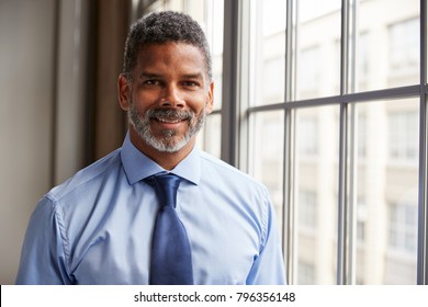 Middle aged black businessman smiling to camera