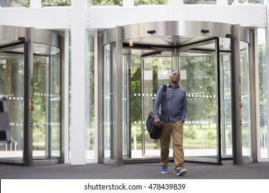 Middle Aged Black Man Entering The Foyer Of Modern Building