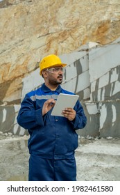 Middle aged builder using tablet at building place