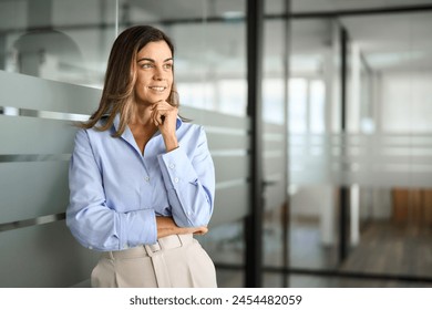 Middle aged business woman investor entrepreneur standing in office looking away. Mature professional businesswoman corporate leader ceo manager at work thinking of future success. Copy space. - Powered by Shutterstock