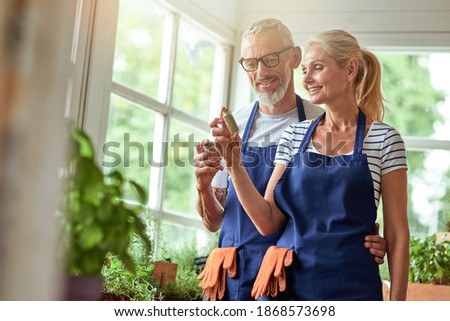 Middle aged caucasian couple looking at dried herbs