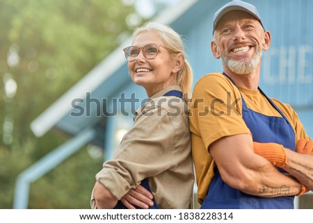 Middle aged caucasian couple on garden house background