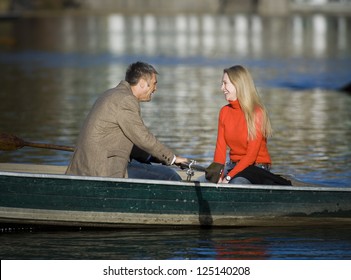 Middle Aged Couple In Canoe Laughing