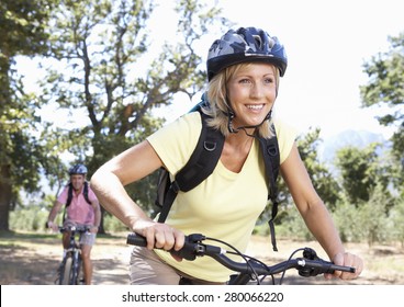 Middle Aged Couple Cycling Through Countryside