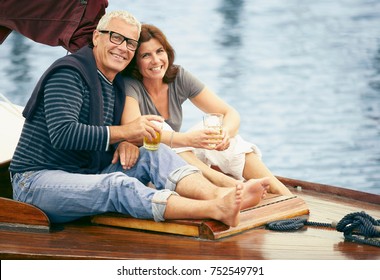 Middle Aged Couple Drinking On Boat