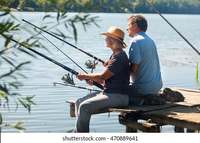 Middle Aged Couple Fishing On The Lake