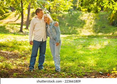 Middle Aged Couple Hugging In The Park