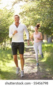 Middle Aged Couple Jogging In Park