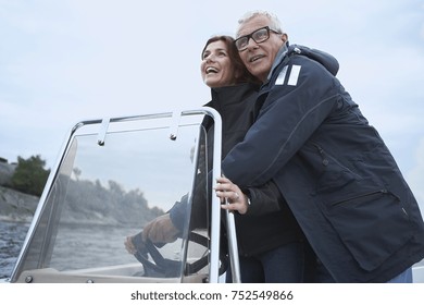 Middle Aged Couple On Motor Boat