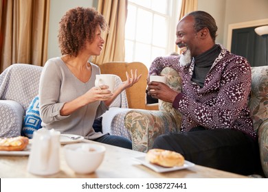 Middle Aged Couple Sitting Around Table In Coffee Shop