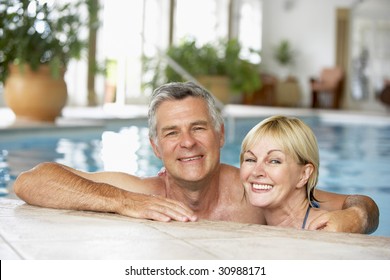 Middle Aged Couple In Swimming Pool