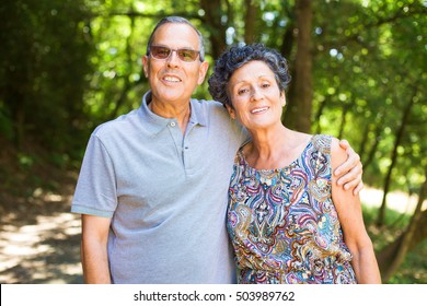 Middle Aged Couple Walking In The Forest