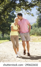 Middle Aged Couple Walking Through Countryside