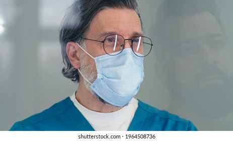 Middle Aged Doctor Interviewing Patient On Reception