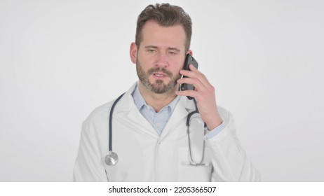 Middle Aged Doctor Talking On Smartphone, White Background