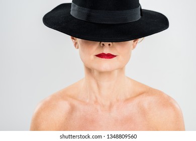 Middle Aged Elegant And Fashionable Woman With Red Lips In Black Hat Isolated On Grey 