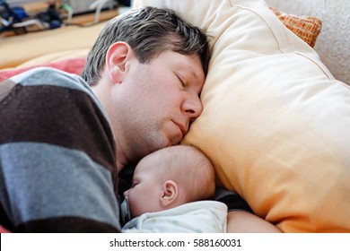 Middle Aged Father Sleeping Near His Newborn Baby Daughter. Young Dad Cuddling With Baby Girl At Home. Happy Parenthood, Carefree Childhood, Family, Love. Cute Adorable Baby Sleeping