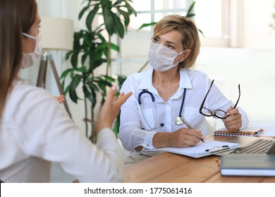 Middle Aged Female Doctor Therapist In Medical Mask On Consultation With Patient In Office.