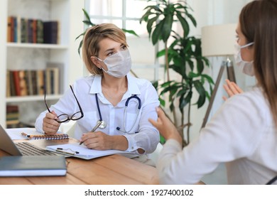 Middle Aged Female Doctor Therapist In Medical Mask On Consultation With Patient In Office.