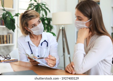 Middle Aged Female Doctor Therapist In Medical Mask On Consultation With Patient In Office.