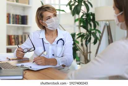 Middle Aged Female Doctor Therapist In Medical Mask On Consultation With Patient In Office.