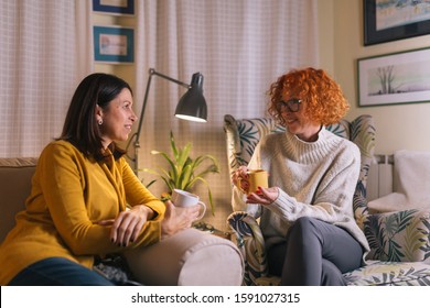 Middle Aged Female Friends Having Fun At Home, Drinking Coffee And Talking