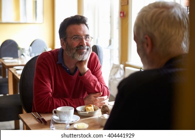 A Middle Aged Gay Male Couple Having Lunch In A Restaurant