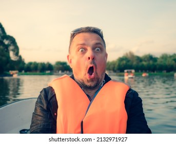 Middle Aged Handsome Man Wearing Nautical Lifejacket Afraid And Shocked With Surprise Expression, Fear And Excited Face On Lake Background.