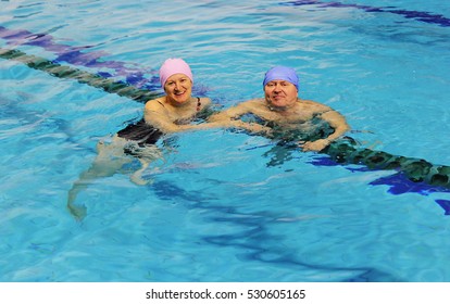 Middle Aged Happy Couple In Swimming Pool