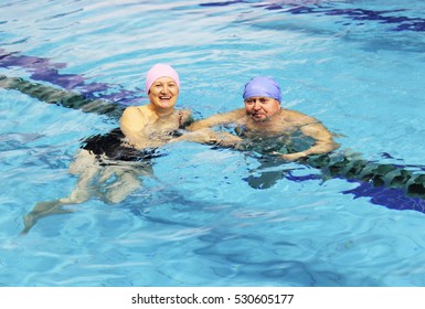 Middle Aged Happy Couple In Swimming Pool