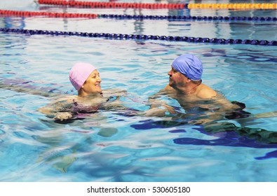 Middle Aged Happy Couple In Swimming Pool