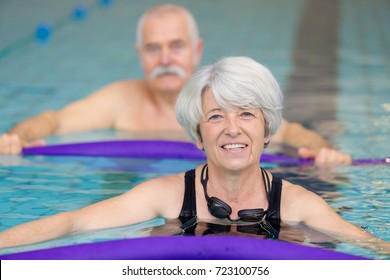 Middle Aged Happy Couple In Swimming Pool