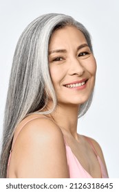 Middle aged happy mature asian woman, senior 50 year lady looking at camera, isolated on white closeup face portrait. Ads of antiaging uv protection whitening menopause dry skincare, plastic surgery.