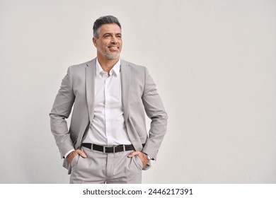 Middle aged happy professional business man investor looking away, smiling mature stylish rich confident businessman executive leader wearing gray suit standing isolated on white wall. Copy space. - Powered by Shutterstock