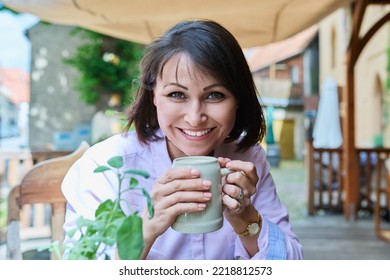 Middle Aged Happy Woman With Ceramic Beer Mug In German Outdoor Pub