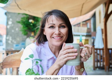 Middle Aged Happy Woman With Ceramic Beer Mug In German Outdoor Pub