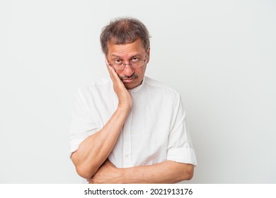 Middle aged indian man isolated on white background who is bored, fatigued and need a relax day.