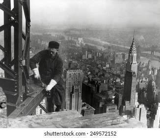 Middle aged iron worker at the Empire State Building construction site, 1930. The Chrysler Building's spire is at right. Photo By Lewis Hine.