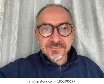 Middle Aged Italian Man With Short Hair And Eyeglasses With Short Gray Beard And Blue Fleece