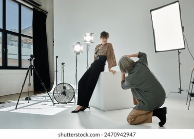 A middle aged lesbian couple in a studio, one setting up camera and the other getting ready as the model. - Powered by Shutterstock